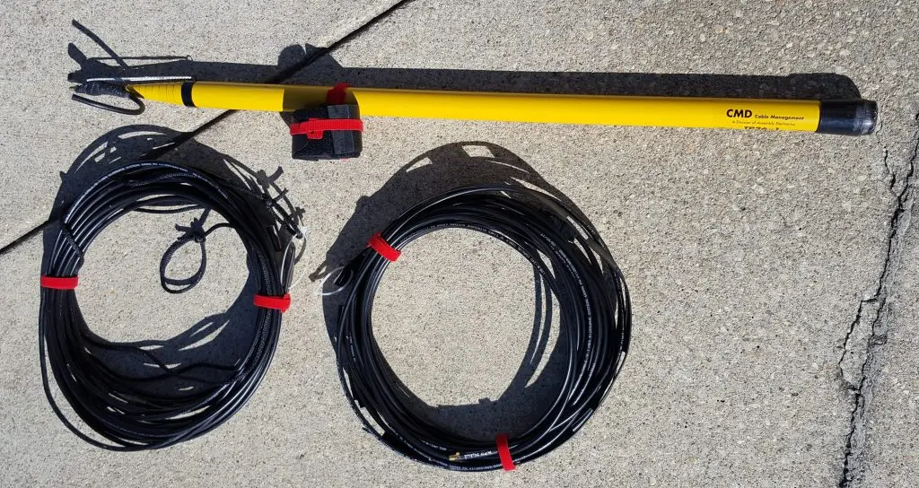 Image of collapsed fibreglass pole, used as mast, straps, and two VHF j-pole antennas rolled up and ready for deployment.