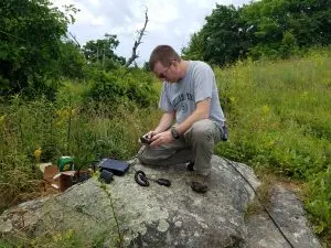 Eric WG3K setting up the APRS digipeater on a boulder. - Photo by Dave KB3RAN